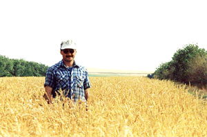Marc Loiselle standing in field of wheat